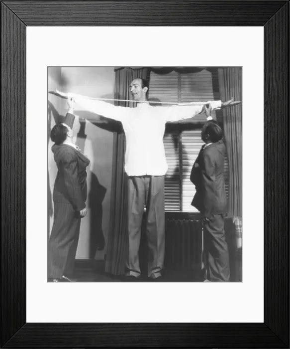 Framed Print : Henry Hite, the Chicago giant, is measured for his shirts. July 31, 1946