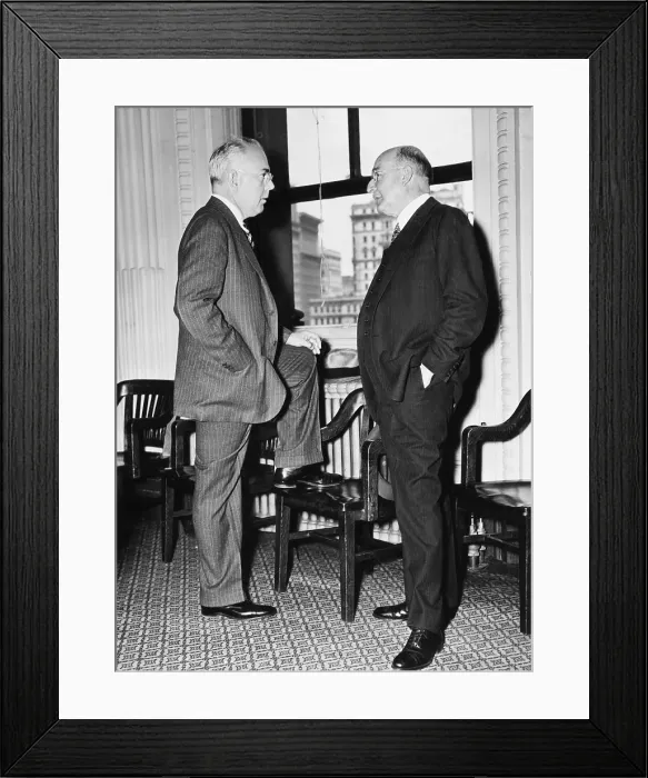 Framed Print : Pierre DuPont, noted Financier (right), talking with his lawyer, James Ivins, at a NYC hearing. May 5, 1937