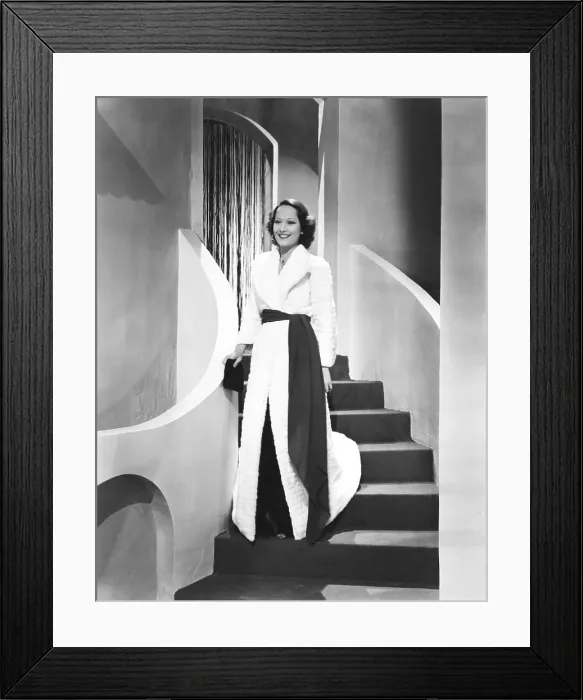 Framed Print : THE DIVORCE OF LADY X, Merle Oberon in white Russian Ermine coat by Paquin and black velvet evening gown designed by Rene Hubert, 1938