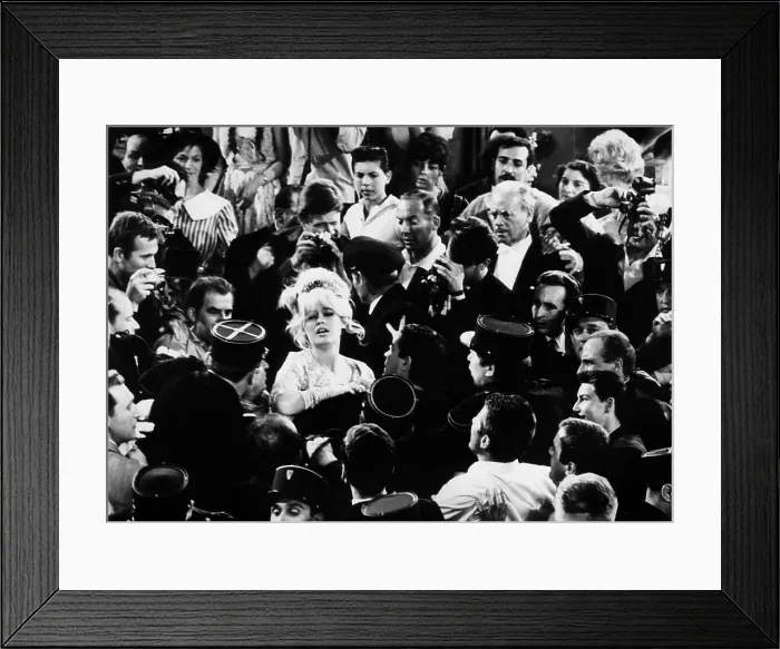 Framed Print : Brigitte Bardot in a 1963 film still. Scene depicts a struggling Bardot crowded by police and photographers. - (CSU_2015_6_221)