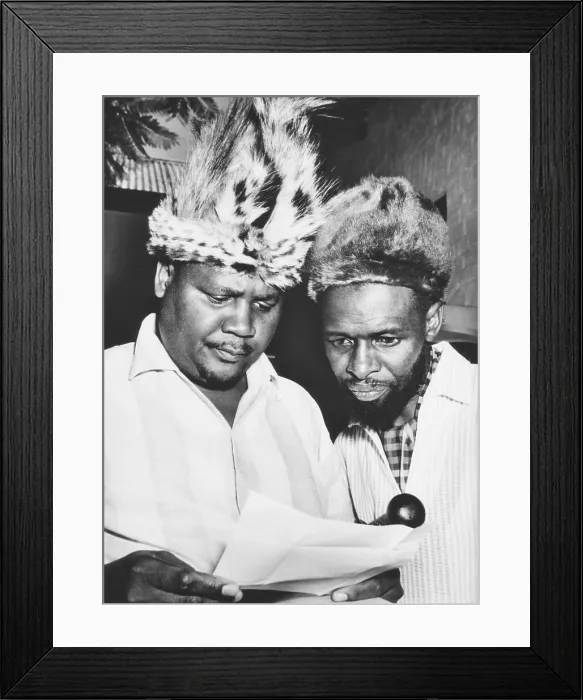 Framed Print : Joshua Nkomo reading a Rhodesian criminal charge against him in April 1963. In 1962 Nkomo founded the Zimbabwe African People's Union (ZAPU)