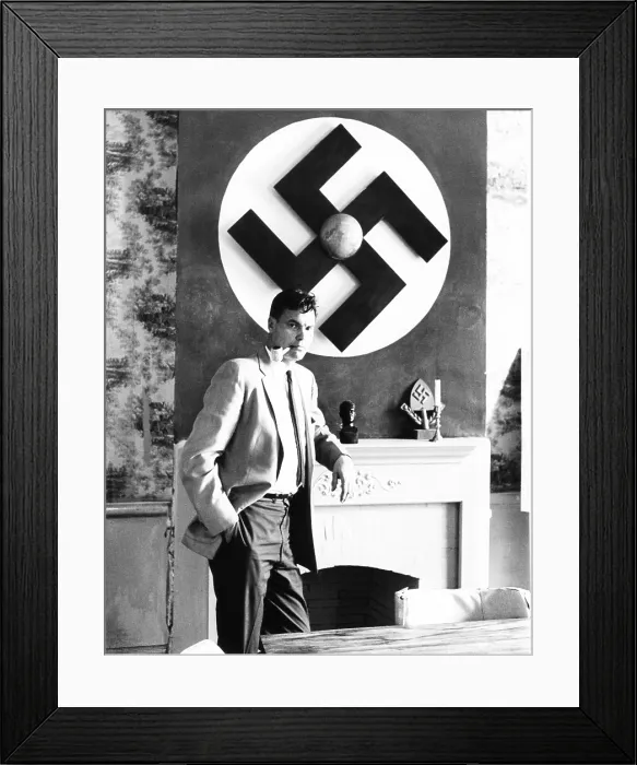 Framed Print : American Nazi George Lincoln Rockwell stands by a huge swastika on the wall over the fireplace Framed Print : American Nazi George Lincoln Rockwell stands by a huge swastika on the wall over the fireplace