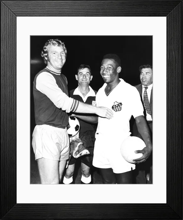 Framed Print : Pele of Santos of Brazil with Bobby Moore, the halfback of West Ham United, England. They were playing a soccer game on New York's Randall's Island on Sept. 22, 1970 Framed Print : Pele of Santos of Brazil with Bobby Moore, the halfback of West Ham United, England. They were playing a soccer game on New York's Randall's Island on Sept. 22, 1970