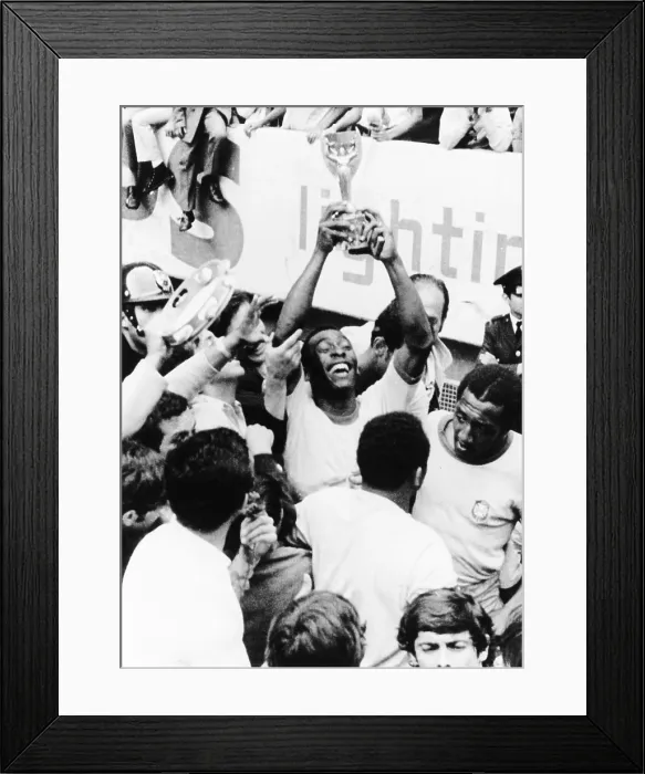 Framed Print : Pele in triumph in Mexico City, June 21, 1970. He holds up the Jules Rimet Cup, won by Brazil for defeating Italy 4-1 in the final World Cup game
