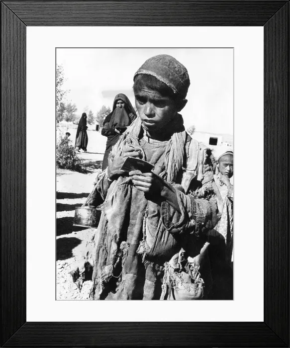 Framed Print : Afghan youngster in a UNICEF feeding line in Chakcharan, Ghor Province. A famine has followed two years of unprecedented drought. Jan 17, 1972