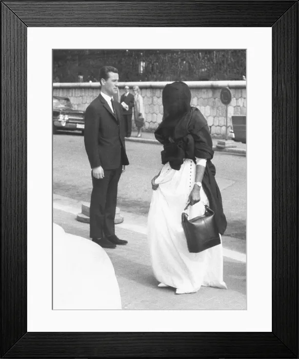 Framed Print : Wearing a dark veil, one of the wives of King Saud of Saudi Arabia enters the Hotel Negresco. King Saud was on a recuperative vacation in Nice, France. March 28, 1963