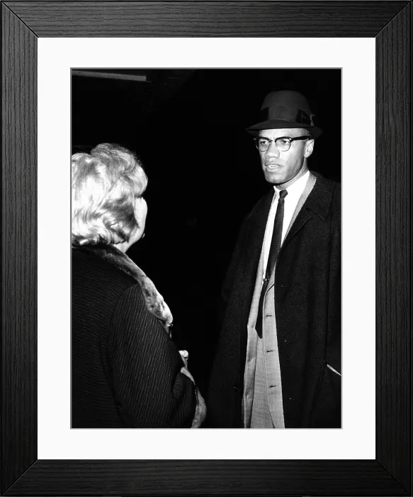 Framed Print : Malcolm X talks to a woman reporter following his television appearance in New York City
