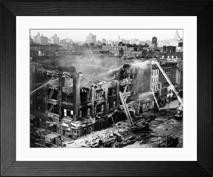 Framed Print : First act of retaliation for the assassination of Malcolm X. Firemen continue to douse the fire that destroyed Nation of Islam Mosque No