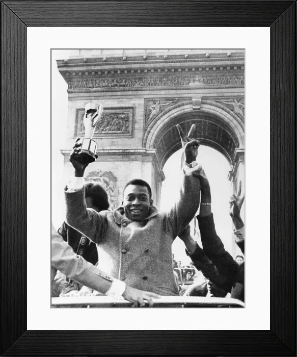 Framed Print : Brazilian soccer star Pele waves the Jules Rimet Cup from an open car on Paris Champs Elysees. March 30, 1971. In the background is the Arc de Triomphe