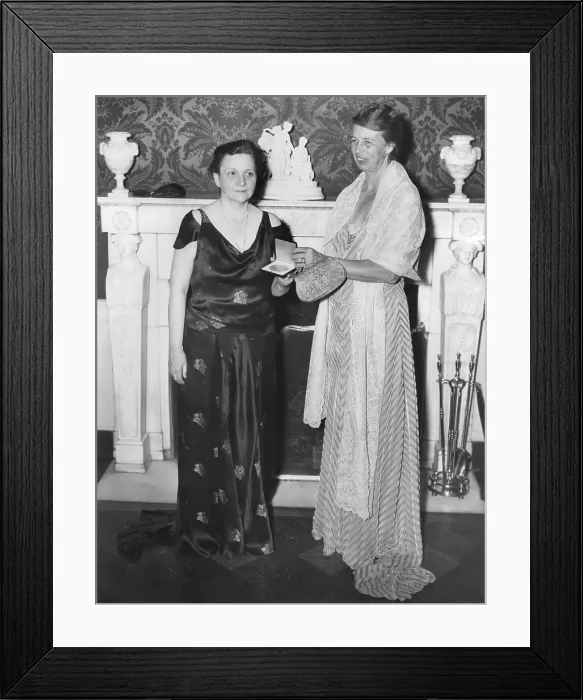 Framed Print : Labor Sec. Frances Perkins receiving a gold medal from Mrs. Eleanor Roosevelt at the White House. Dec. 4, 1934