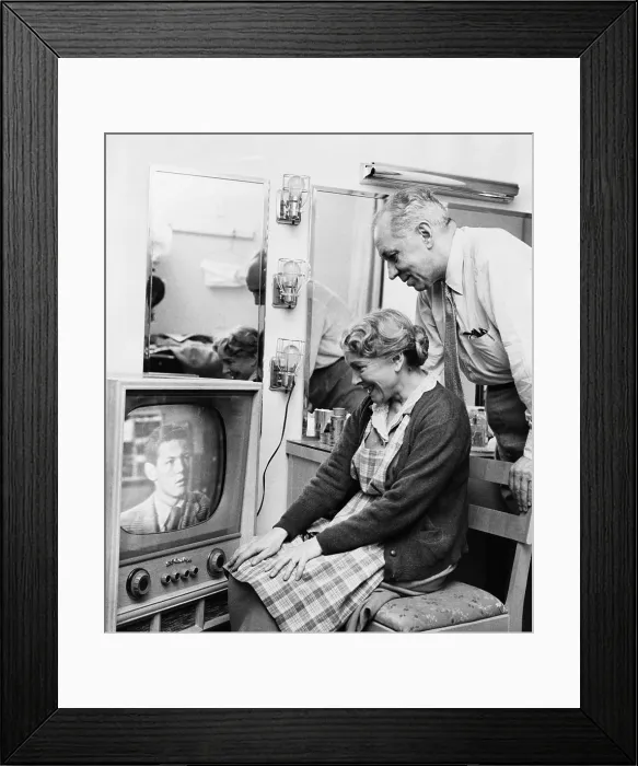 Framed Print : Helen Hayes and Charles MacArthur watch their adopted son Jamie MacArthur's television debut