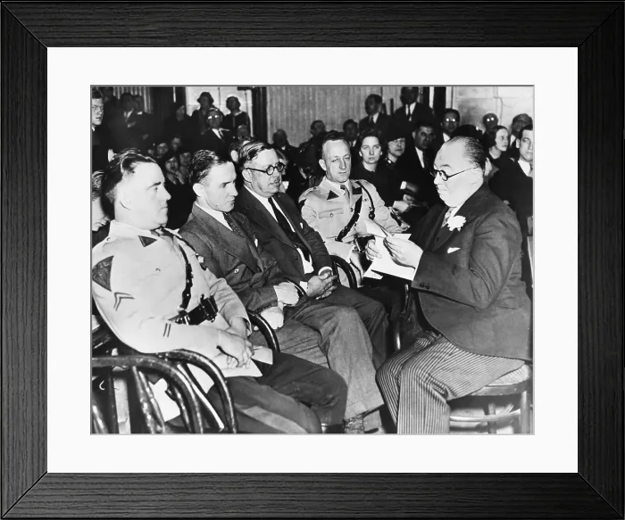 Framed Print : Bruno Hauptmann (2nd from felt) sitting between State Troopers and a Sheriff at his trial. At right holding paper is Hauptmann's defense counsel, Edward J. Reilly