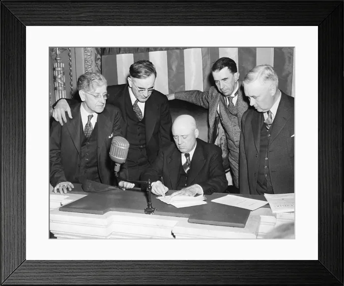 Framed Print : House Speaker, Sam Rayburn, seated on House rostrum, signing the Neutrality Revision Bill. Nov 13, 1941