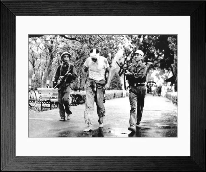 Framed Print : Lieut. Col. James Lindberg Hughes, American F-105 Pilot under guard by North Vietnamese soldiers. May 6, 1967