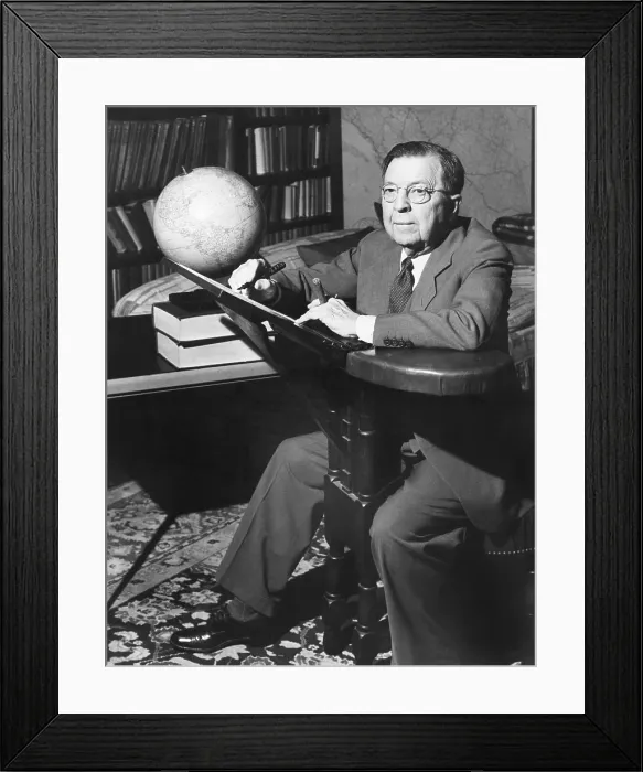 Framed Print : NBC Radio commentator Rupert Hughes at his unique writing chair'. May 1943