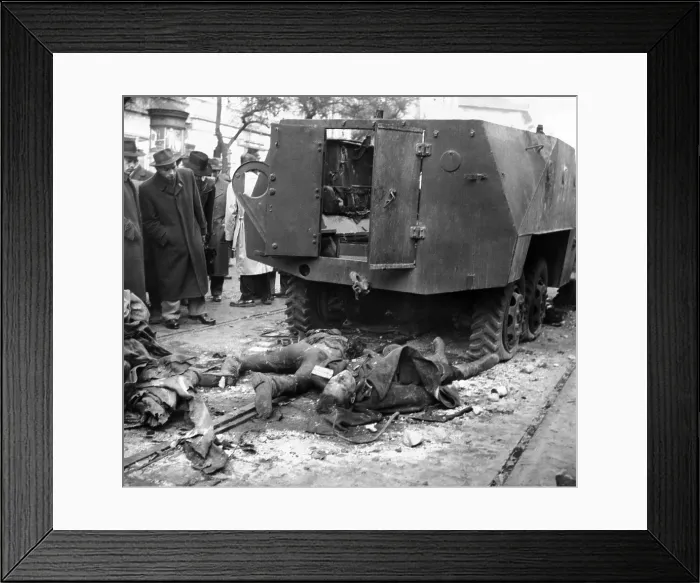 Framed Print : The 1956 Hungarian Uprising. The bodies of two Russian soldiers lying beside their wrecked armored car in a Budapest Street as bystanders look on. Oct. 30, 1956