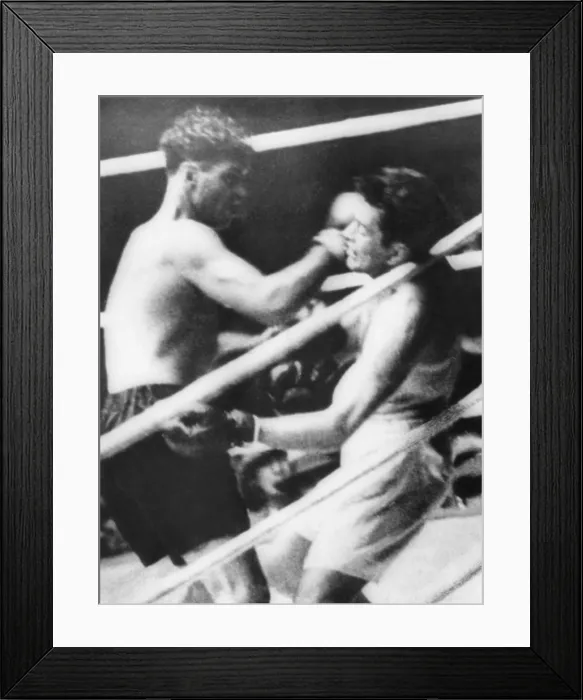 Framed Print : Long Count Fight, the Gene Tunney-Jack Dempsey boxing match of Sept. 22, 1927. Jack Dempsey (dark trunks) batters Tunney against the ropes in the 7th round until he falls
