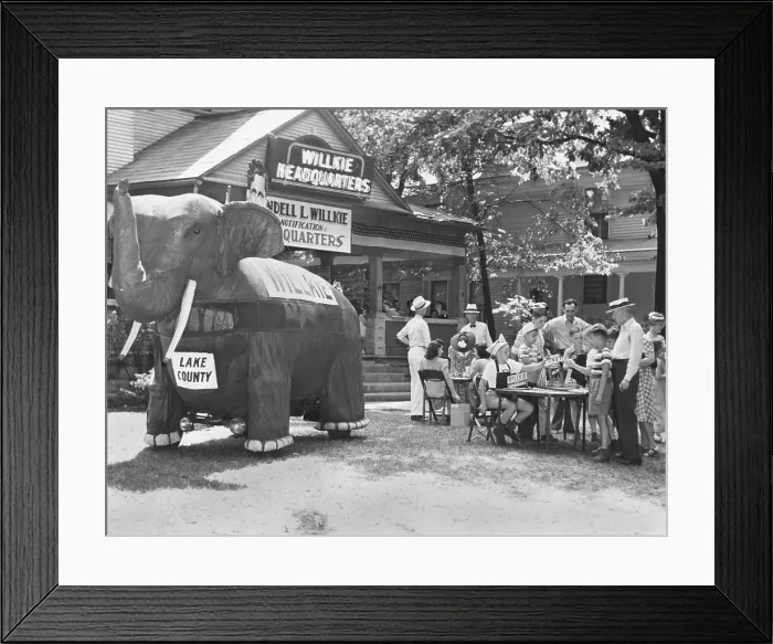 Framed Print : A large cloth elephant attacks shoppers to a souvenir stand at Elwood, Indiana, Aug. 15, 1940 Framed Print : A large cloth elephant attacks shoppers to a souvenir stand at Elwood, Indiana, Aug. 15, 1940