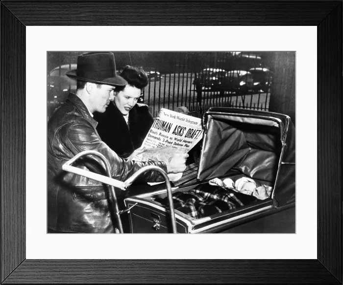 Framed Print : A World War II veteran and his wife, with baby, read headline, Truman Asks Draft! March 17, 1948 Framed Print : A World War II veteran and his wife, with baby, read headline, Truman Asks Draft! March 17, 1948