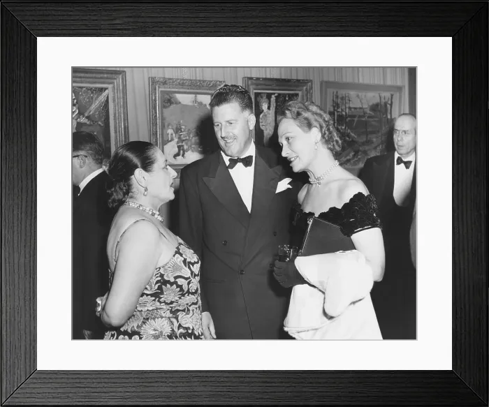Framed Print : Helena Rubenstein, world famous cosmetician and art collector greets guests at her NYC home. Oct. 1950