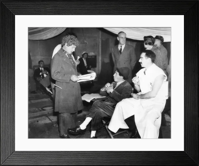 Framed Print : Harpo, Chico and Groucho Marx on the set of MGM's movie, A DAY AT THE RACES. Oct. 8, 1937. Director Sam Wood standing in right background