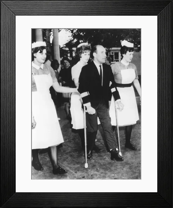 Framed Print : Champion racing driver Sterling Moss on crutches at a British hospital, on June 22, 1962