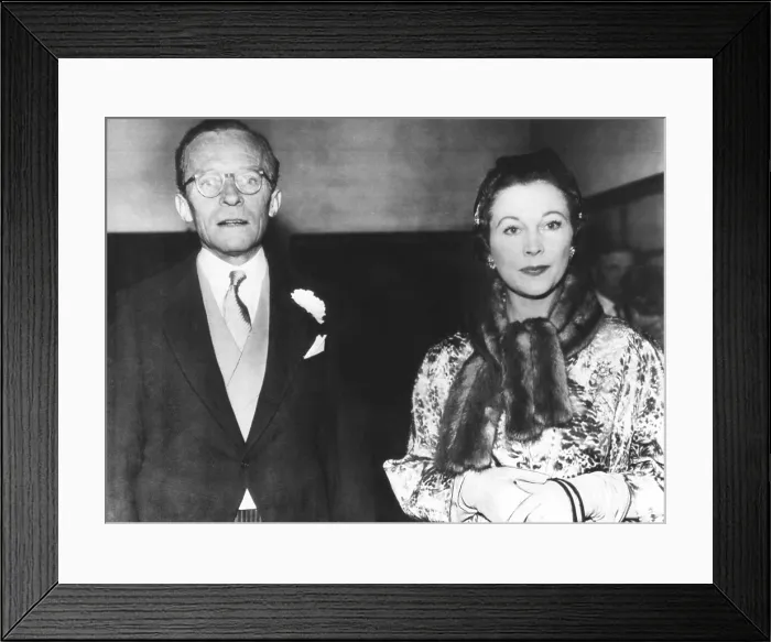 Framed Print : Actress Vivien Leigh with her former husband, Leigh Holman, at the wedding of their daughter. Suzanne Holman married Robin Farrington at Holy Trinity Church, London, Dec. 6, 1957 Framed Print : Actress Vivien Leigh with her former husband, Leigh Holman, at the wedding of their daughter. Suzanne Holman married Robin Farrington at Holy Trinity Church, London, Dec. 6, 1957