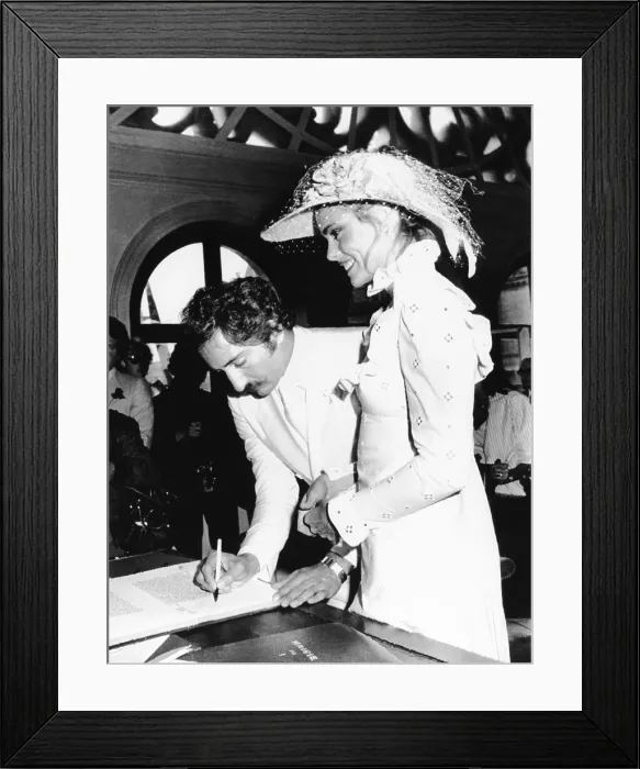 Framed Print : Newly wed Errol Whitson, signs the marriage registry after marrying model Margot Hemingway. They were married at the municipal building of the First Arrondissement in Paris