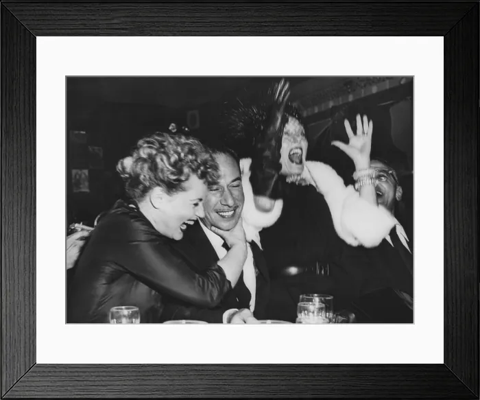 Framed Print : Judy Holiday (left) hugs Jose Ferrer after they heard that Ferrer and Holiday both won Oscars. March 29, 1951. They were in a New York City nightclub with Gloria Swanson (left)