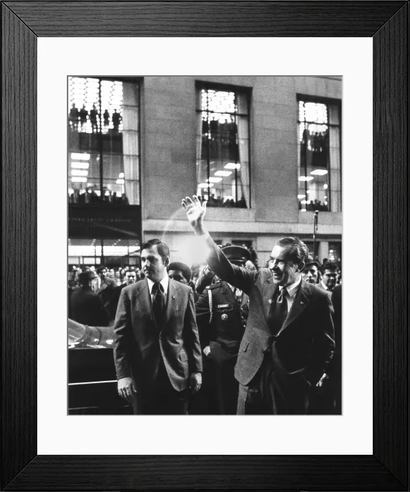 Framed Print : President Richard Nixon waves to crowd on Broad Street in the Financial District of NYC. Nov. 24, 1972. At left is Press Secretary Ron Ziegler