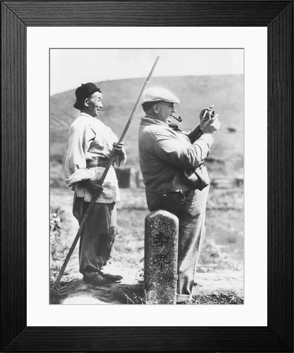 Framed Print : Director Karl Freund testing the light conditions on the set of THE GOOD EARTH, near Hollywood. Jan. 21, 1937