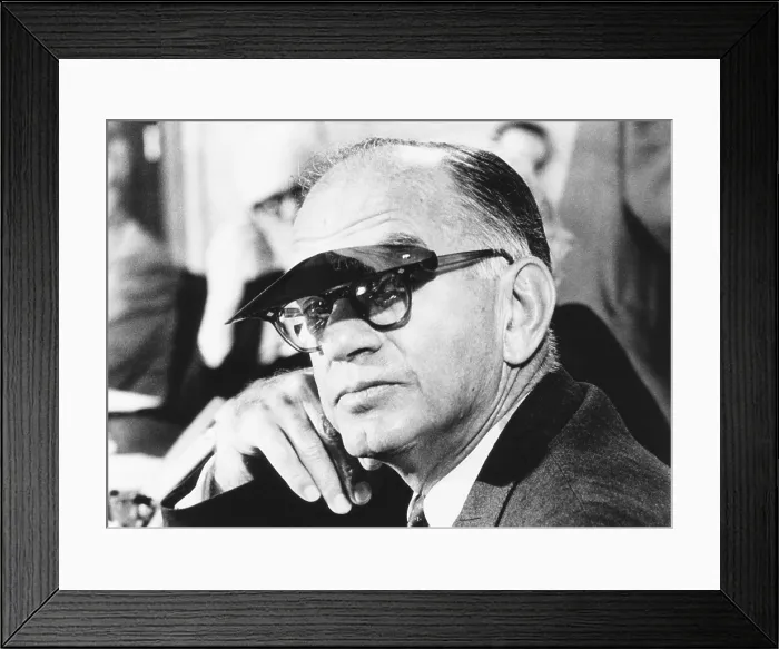 Framed Print : Sen. J. William Fulbright wears a sun visor to shield his eyes from the TV lights. Mar. 11, 1969