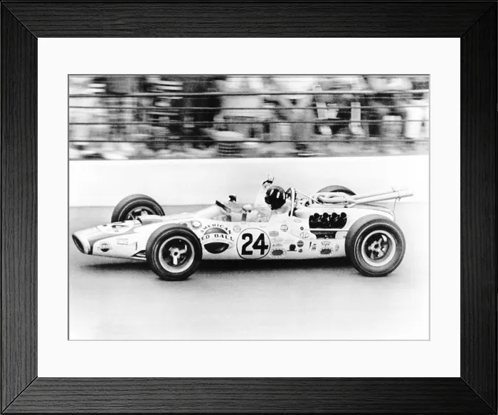 Framed Print : Graham Hill, waves as his car streaks toward the finish line to win the Indianapolis 500. May 30, 1966