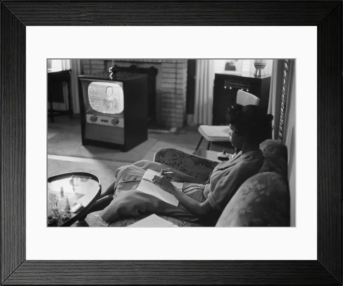 Framed Print : Civil Rights, an African American high school girl being educated via television during the period that schools were closed to avoid integration, photograph by Thomas J