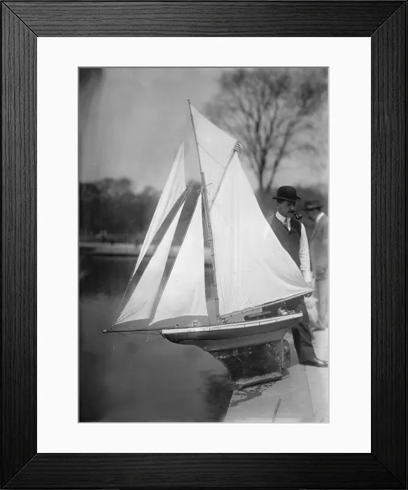 Framed Print : New York City, man with toy yacht in Central Park, circa 1910s