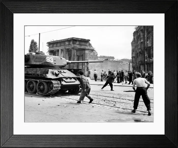 Framed Print : Anti-Communist riots in East Germany. An East Berliner throws stones at a Russian tank during the first violent resistance in a Soviet post war satellite state Framed Print : Anti-Communist riots in East Germany. An East Berliner throws stones at a Russian tank during the first violent resistance in a Soviet post war satellite state