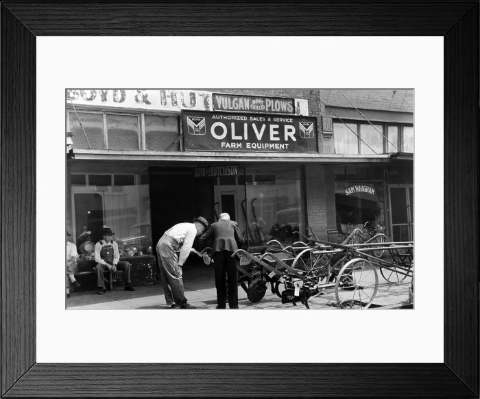 Framed Print : Farmer looking at new equipment, Saturday afternoon, Enterprise, Alabama, photograph by Marion Post Wolcott, circa 1939