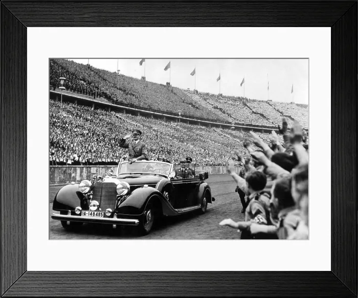 Framed Print : BERLIN--Adolph Hitler (in auto) salutes the huge, cherring crowd in Olympic Stadium upon his arrival to address a May Day youth parade. 5 / 8 / 39 Framed Print : BERLIN--Adolph Hitler (in auto) salutes the huge, cherring crowd in Olympic Stadium upon his arrival to address a May Day youth parade. 5 / 8 / 39
