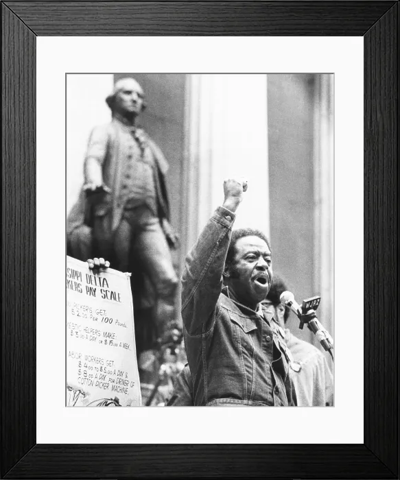 Framed Print : Rev. Ralph Abernathy speaks with a clenched fist on Wall Street on April 5, 1971. 4000 protestors marched in the Financial District demanding a guaranteed annual income of $6500