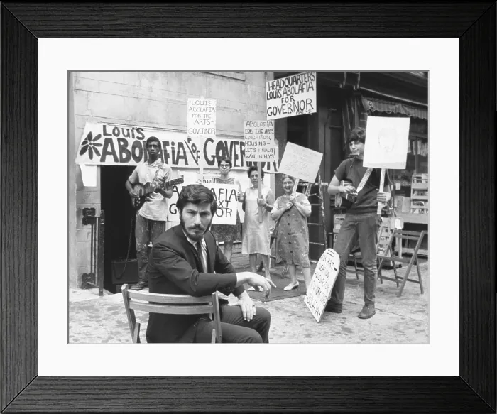 Framed Print : Louis Abolafia, an artist sought a complete rebirth of the arts by running for governor New York. August 16, 1966. Behind him are his supporters and their campaign signs