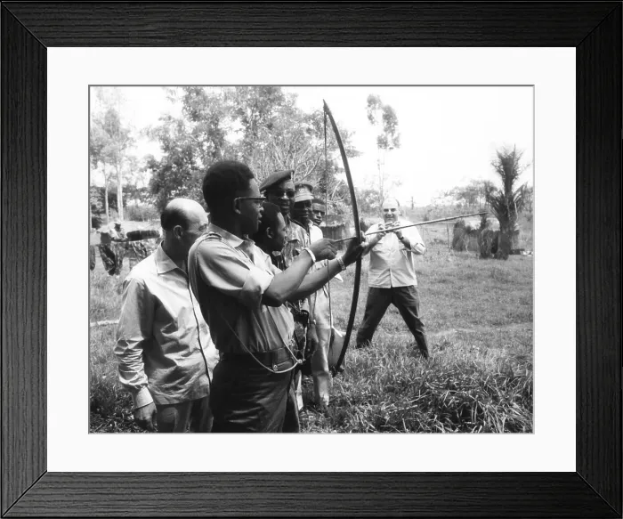 Framed Print : Gen. Joseph Mobutu, Chief of the Congolese Army, demonstrates his skill with bow and arrow. March 23, 1964 Framed Print : Gen. Joseph Mobutu, Chief of the Congolese Army, demonstrates his skill with bow and arrow. March 23, 1964