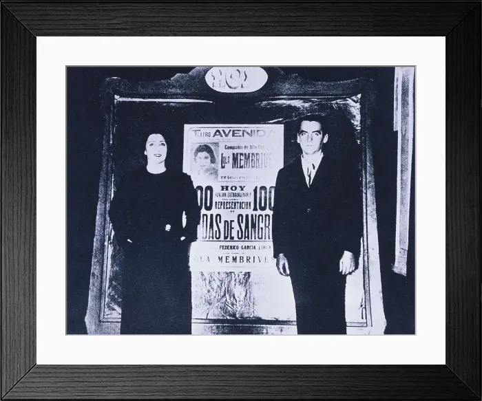 Framed Print : Federico Garca Lorca and the actress Lola Membrives before the poster advertising the 100 performances of the work 'Bodas de Sangre' (Blood Wedding)