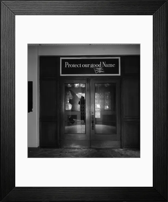 Framed Print : Los Angeles, broken door of Goodyear Rubber Company, the sign above reads: Protect our good name, Goodyear, 6701 South Central Avenue, Los Angeles, California