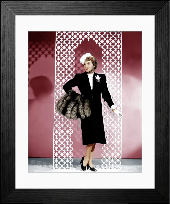 Framed Print : MIDNIGHT, Claudette Colbert, in a black wool suit by Irene, with a crystal-beaded blouse and silver fox muff, 1939