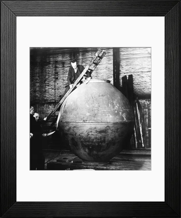 Framed Print : Auguste Piccard on a ladder examining the nacelle construction in his workshop Framed Print : Auguste Piccard on a ladder examining the nacelle construction in his workshop