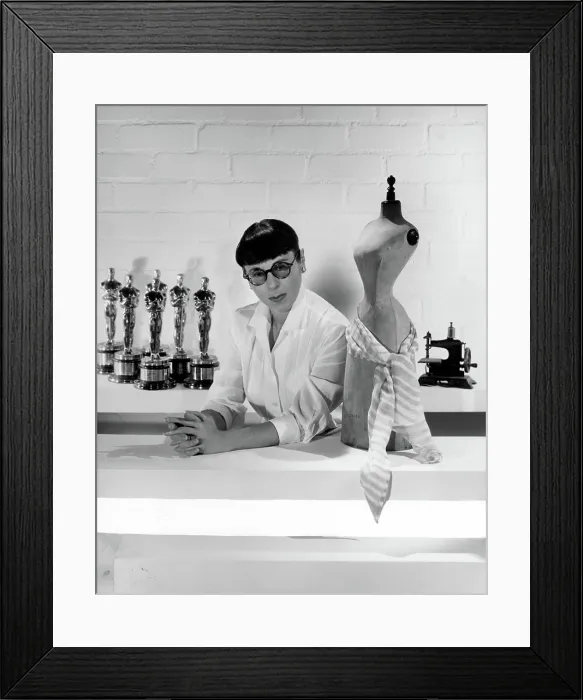 Framed Print : EDITH HEAD, posing with Oscars she has won, c. 1960.. Courtesy: CSU Archives  /  Everett Collection