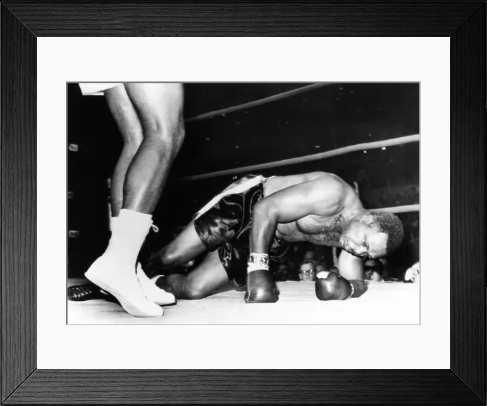 Framed Print : Archie Moore on the canvas in the fourth round of his fight with 20 year old Cassius Clay. Nov. 15, 1962