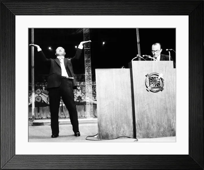 Framed Print : Sun Myung Moon, Korean evangelist, gestures as he speaks at Madison Square Garden. New York City, Sept. 18, 1974. His chief associate, Col
