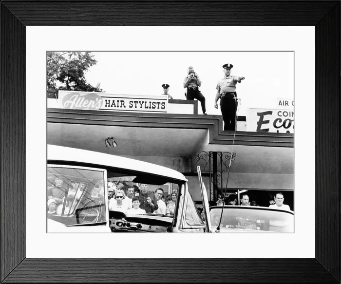 Framed Print : Crime scene where a sniper killed American Nazi party leader George Lincoln Rockwell. Police stand on the roof of the coin laundry, from which the deadly shots were fired