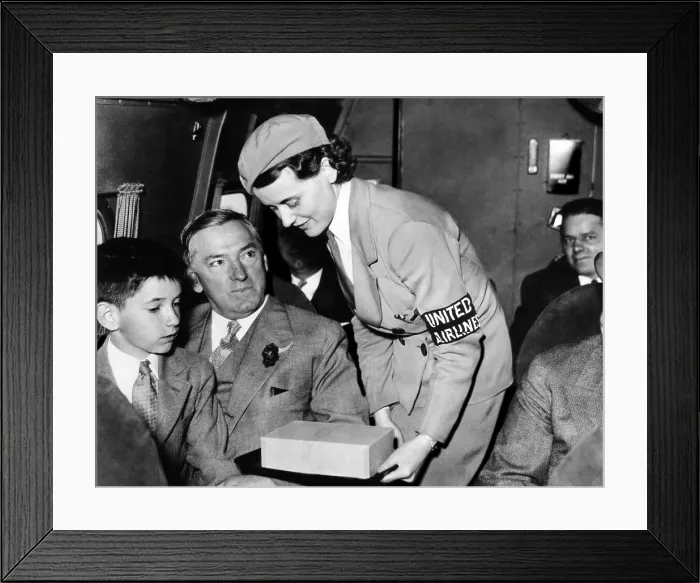 Framed Print : United Airlines stewardess assists Mayor James Curley of Boston. He went on to become the governor of Massachusetts, 1934. Courtesy: CSU Archives / Everett Collection